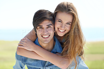 Buy stock photo An affectionate young couple standing together in the outdoors
