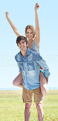 Buy stock photo A young man piggybacking his girlfriend in the outdoors