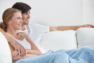 Buy stock photo Smile, relax and couple watching tv on sofa in living room of home for subscription service streaming. Love, movie or television with happy young man and woman in apartment together for bonding