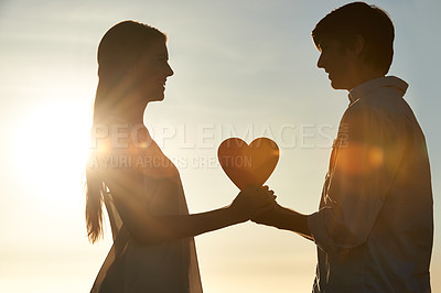 Buy stock photo Silhouette, couple and happy with heart shape in nature, commitment and love symbol for marriage by blue sky. Man, woman and valentines day on romantic date and lens flare for bonding on honeymoon