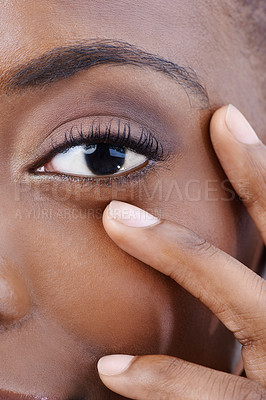 Buy stock photo Closeup, eye and black woman with beauty, vision and skincare with dermatology. Half, portrait and African model with natural makeup and hand on face with healthy skin from cosmetics or facial
