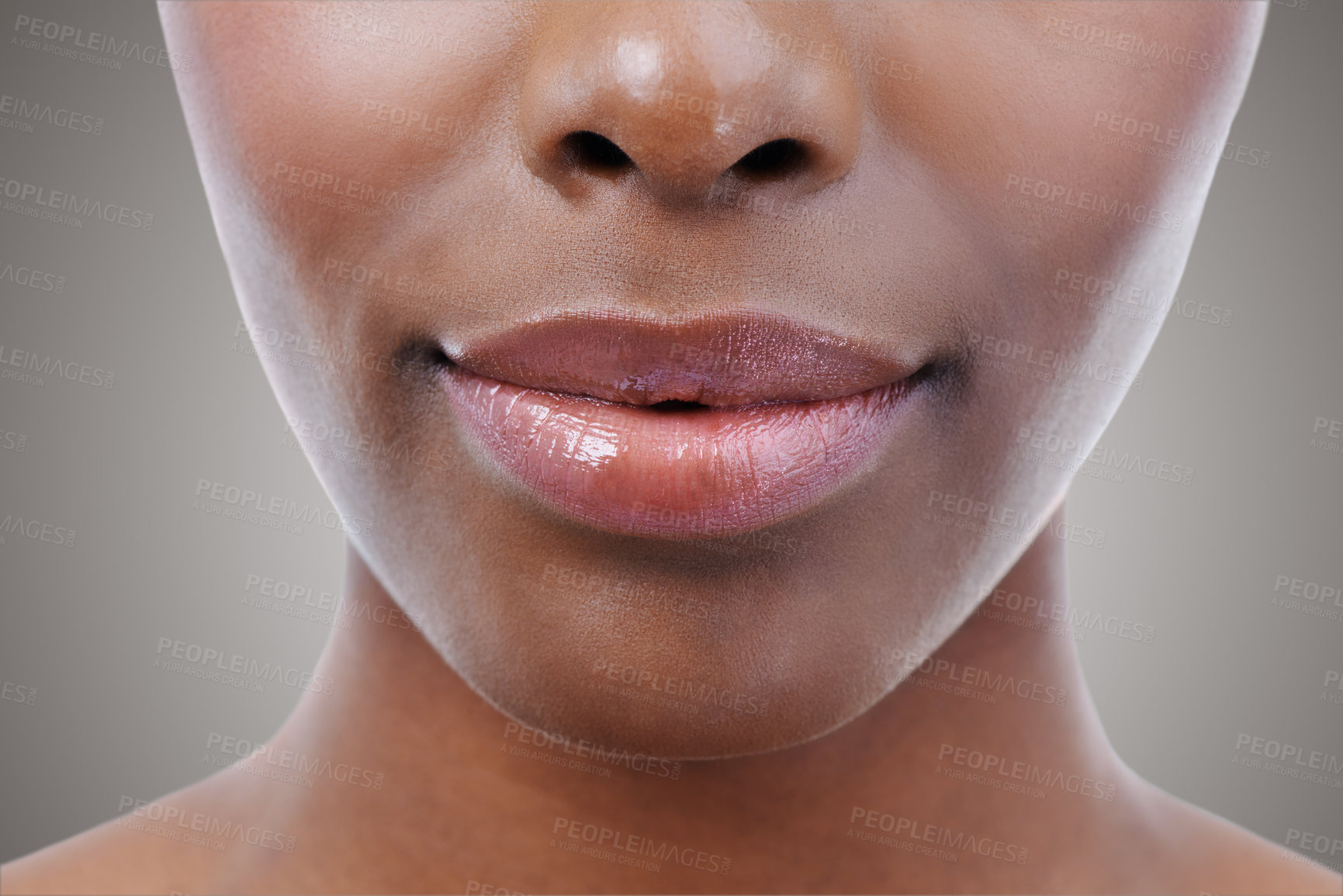 Buy stock photo Cosmetics, beauty and lips of black woman on gray background for wellness, skincare and makeup. Dermatology, salon aesthetic and face closeup of person with gloss, lipstick and natural skin in studio