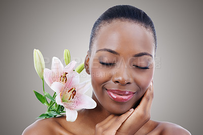 Buy stock photo Eyes closed, flower and black woman with cosmetics, skincare and treatment on white studio background. African person, girl and model with natural beauty and grooming with shine, wellness and glow