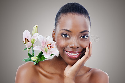 Buy stock photo Flower, skin and  black woman in portrait, beauty and dermatology with wellness in studio on grey background. Healthy glow, eco friendly skincare and orchid for treatment, face and natural cosmetics