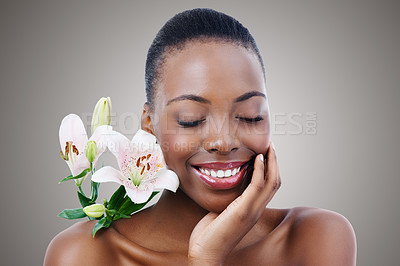 Buy stock photo Eyes closed, flower and black woman with beauty, shine and treatment on grey studio background. African person, girl and model with natural cosmetics and skincare with aesthetic, smile and glowing
