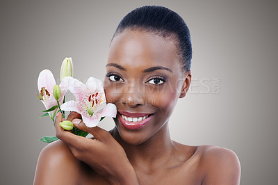 Buy stock photo Portrait, smile for beauty and black woman with flowers in studio on gray background for natural skincare. Face, happy and confident young model with orchid for aesthetic wellness or cosmetics