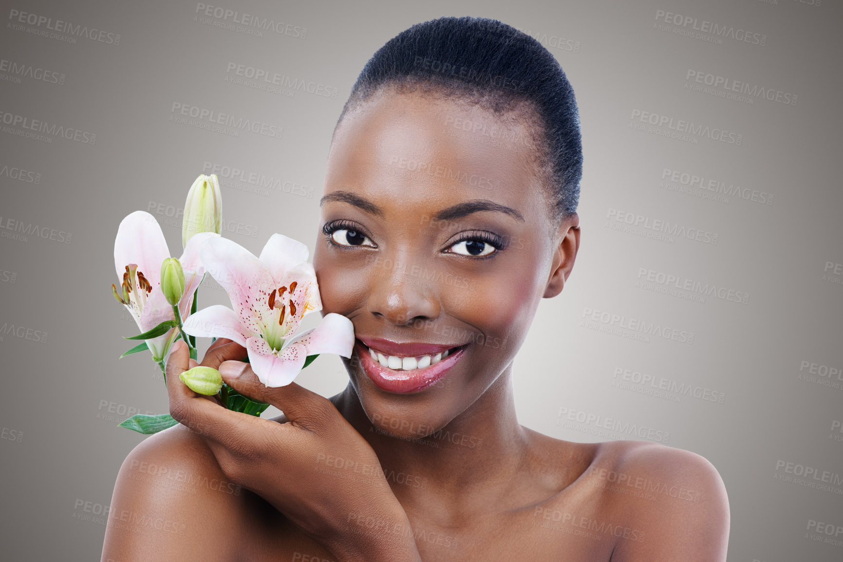 Buy stock photo Portrait, smile for beauty and black woman with flowers in studio on gray background for natural skincare. Face, happy and confident young model with orchid for aesthetic wellness or cosmetics