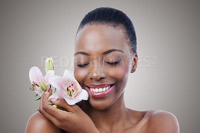 Buy stock photo A beautiful African woman posing with flowers - closeup