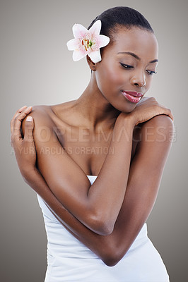 Buy stock photo Skincare, beauty and a black woman with a flower for organic makeup and cosmetics on a grey background. Orchid, plant and natural dermatology with an African female person for cosmetology treatment