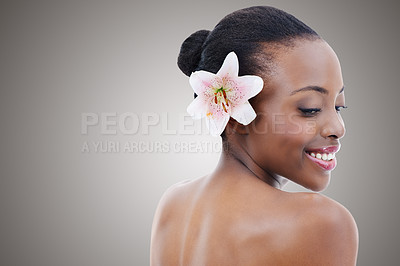 Buy stock photo Skincare, beauty and black woman with flower on gray background for wellness, cosmetics and makeup. Dermatology mockup, salon and person smile for aesthetic, natural products and facial in studio