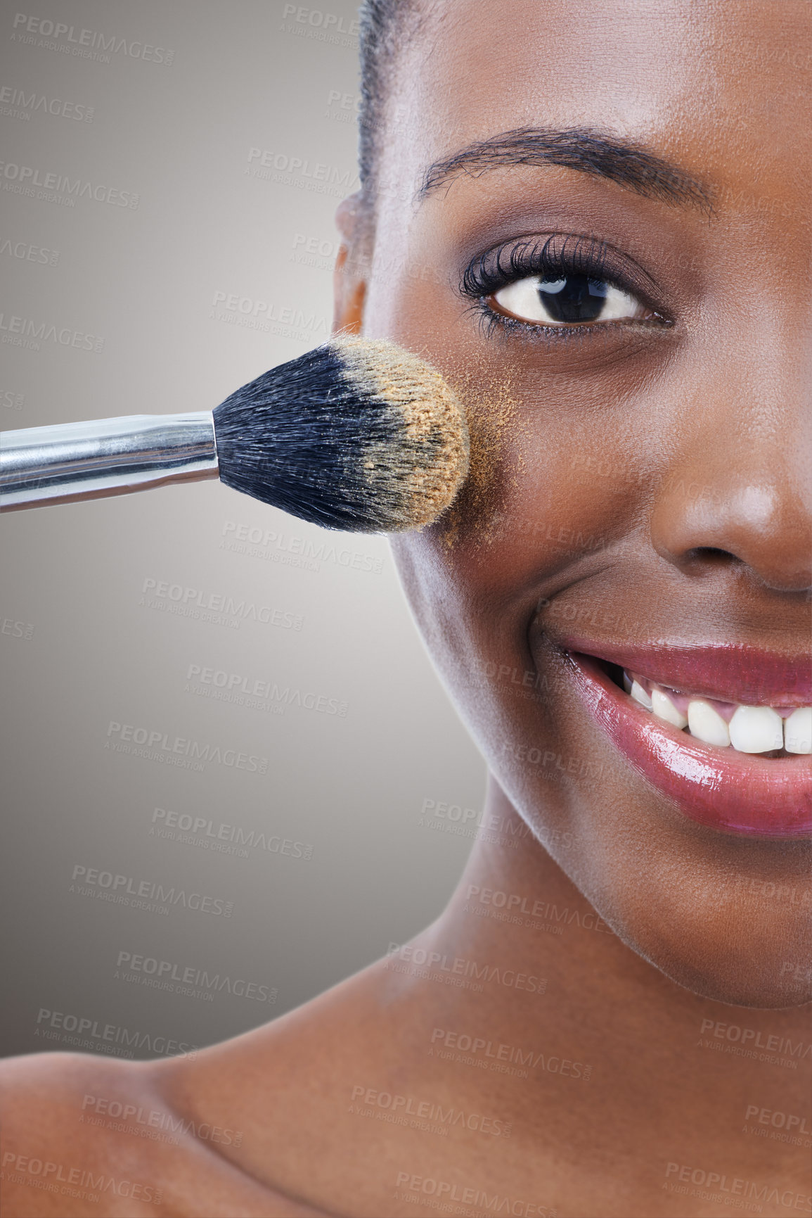 Buy stock photo Brush, makeup and black woman, portrait and beauty with foundation for cosmetics, wellness and cropped on grey background. Shine, cosmetology and tools to apply powder, glow and shimmer in studio