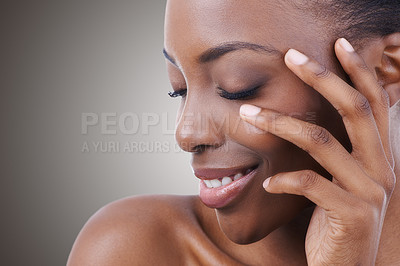 Buy stock photo Cropped shot of a beautiful young woman touching her face with her eyes closed