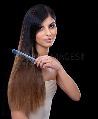 Buy stock photo A gorgeous young woman combing her long and lustrous hair