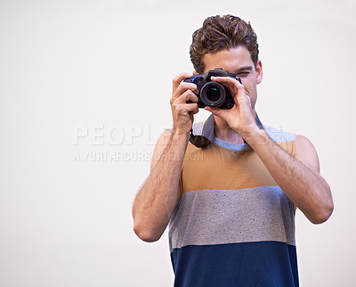 Buy stock photo Young man taking a photograph of you
