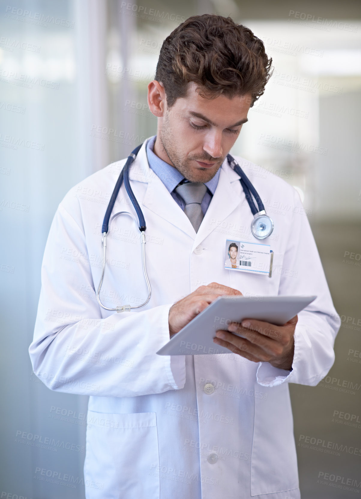 Buy stock photo Research, tablet and doctor in hospital for medical information on the internet for diagnosis. Reading, professional and male healthcare worker with telehealth on digital technology in clinic.