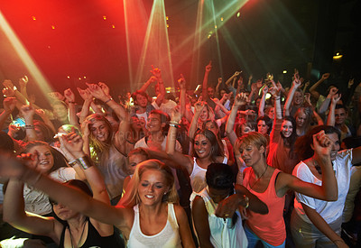 Buy stock photo Concert music, rock and crowd of people with disco party lights for dance, performance and singing together in psychedelic festival. Night club, techno and rave with group of people or youth dancing