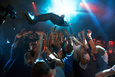 Buy stock photo Music artist, stage dive and concert for party, nightclub or dance festival in the crowd or audience indoors. DJ, music concert and crowds of people ready to catch performer in celebration for event