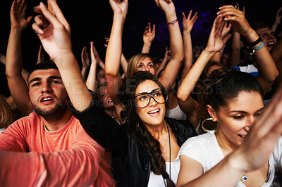 Buy stock photo Crowd, concert and people in stadium for music, rock or event with community, energy or hands in air. Group, fans and party for music festival, dance or friends together in arena in night in New York