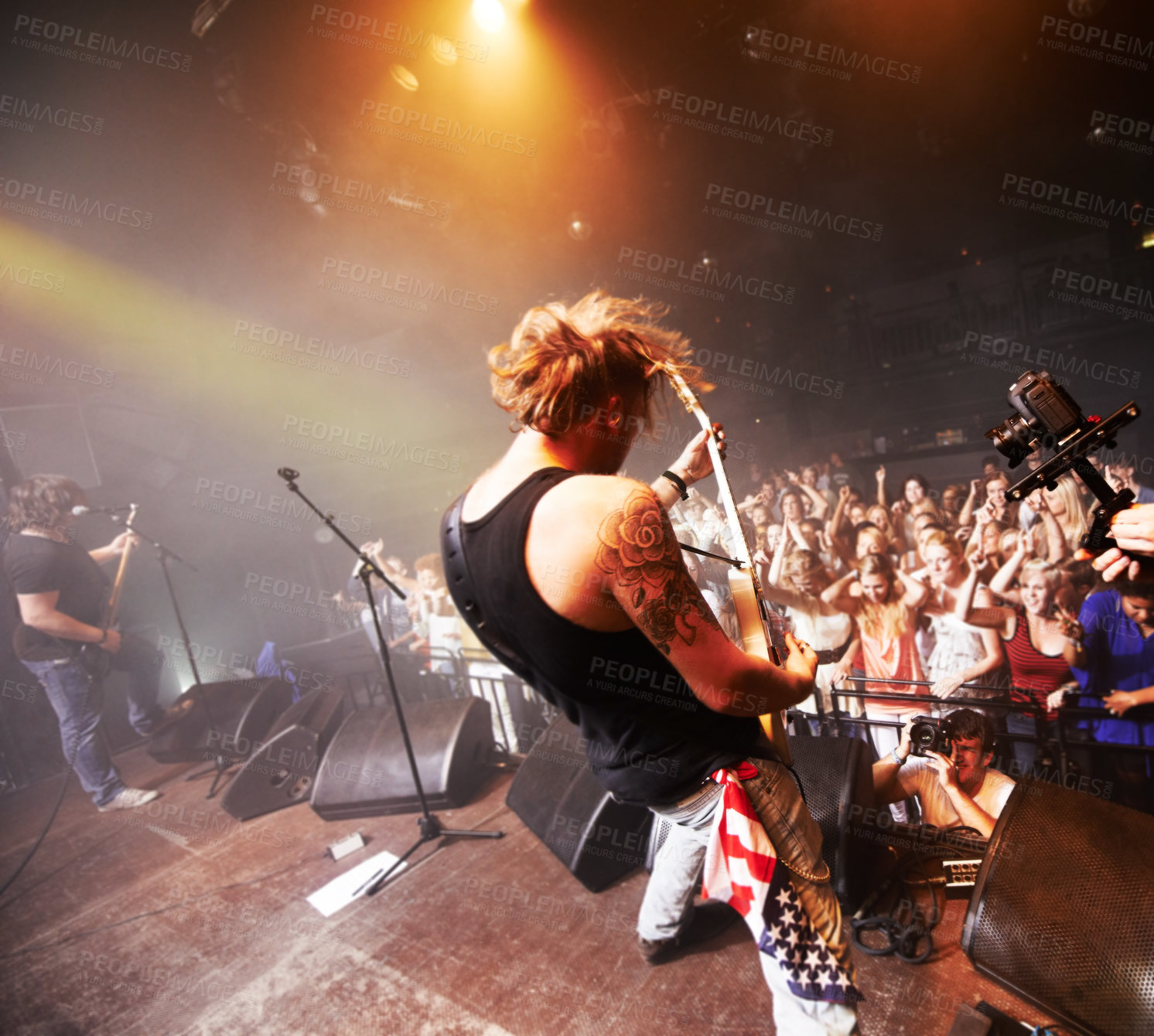 Buy stock photo Rock, music festival and band guitar performance with crowd, fans and people cheering. Punk concert, man musician and fun social party event with music celebration and new year show at nightclub