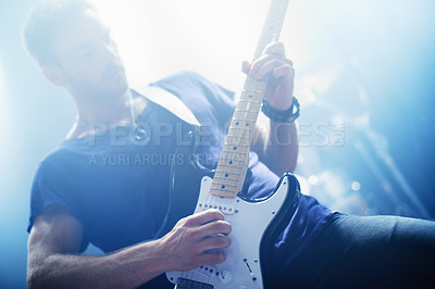 Buy stock photo Cropped view of a rock star playing the guitar during a gig-This concert was created for the sole purpose of this photo shoot, featuring 300 models and 3 live bands. All people in this shoot are model released