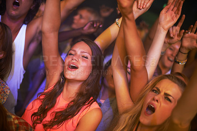 Buy stock photo Music, energy and party with woman at concert for rock, live band performance and festival show. New year, celebration and disco with girl dance in crowd of fans for techno, rave and nightclub event