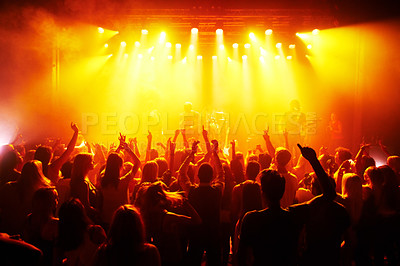 Buy stock photo Rock hands, concert and music festival with crowd red disco lights for energy, dark and gen z psychedelic dance, celebration and party. Band, musician and group of people in the audience with freedom