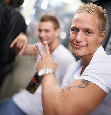 Buy stock photo Close up of an attractive male with huge biceps smiling at the camera and holding a beer