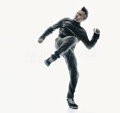 Buy stock photo Man, dance in studio and leg in the air, dancing or play fighting for funny, joke or comedy on white background. Person, dancing and legs kicking or portrait of movement, kick and expression