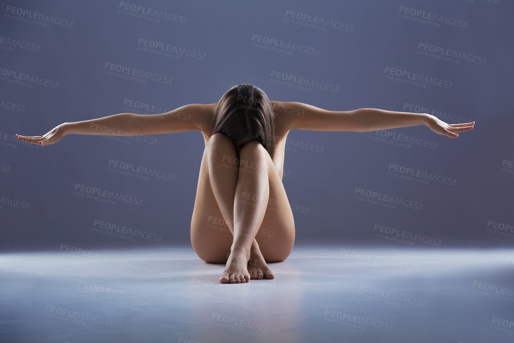 Buy stock photo Woman, naked and sitting with arms stretching on studio floor, art and aesthetic on blue background. Erotic dance, body and nude model with creativity, self expression or stretch with sensual balance