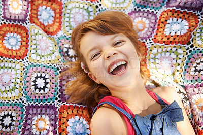 Buy stock photo Portrait, top view and happy kid on blanket outdoor, smile and relax in summer. Funny, above and face of young girl child with excited facial expression for comedy, joke and laughing in Australia