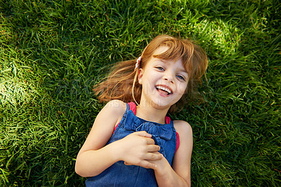 Buy stock photo Child, portrait and grass with smile or above for relax holiday in countryside for summer vacation, nature or park. School kids, face and happy in California environment for laugh, sunshine or meadow
