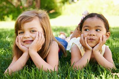 Buy stock photo Smile, nature and portrait of children on grass playing together in outdoor park or garden on vacation. Happy, bonding and young girl kid friends relaxing on lawn in field on holiday or weekend.