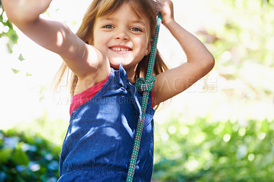 Buy stock photo Portrait, smile and child on swing at park, playing game and having fun outdoor in nature in summer. Face, kid and girl on rope at garden for recreation, leisure and ride at playground in Australia