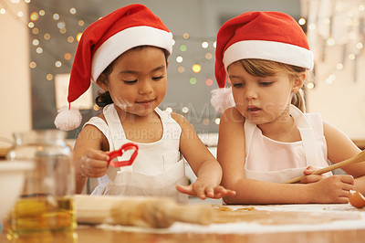 Buy stock photo Kitchen, friends and children baking a christmas cookie, cake or dessert together at their home. Happy, interracial and young girl kids cooking festive, holiday and celebration sweet treats for party