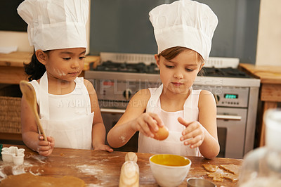 Buy stock photo Children bake in kitchen for learning and development of baker skill, fun with baking ingredients and chef hat with apron. Childhood, focus and girl kids making cookies, diversity and work together.