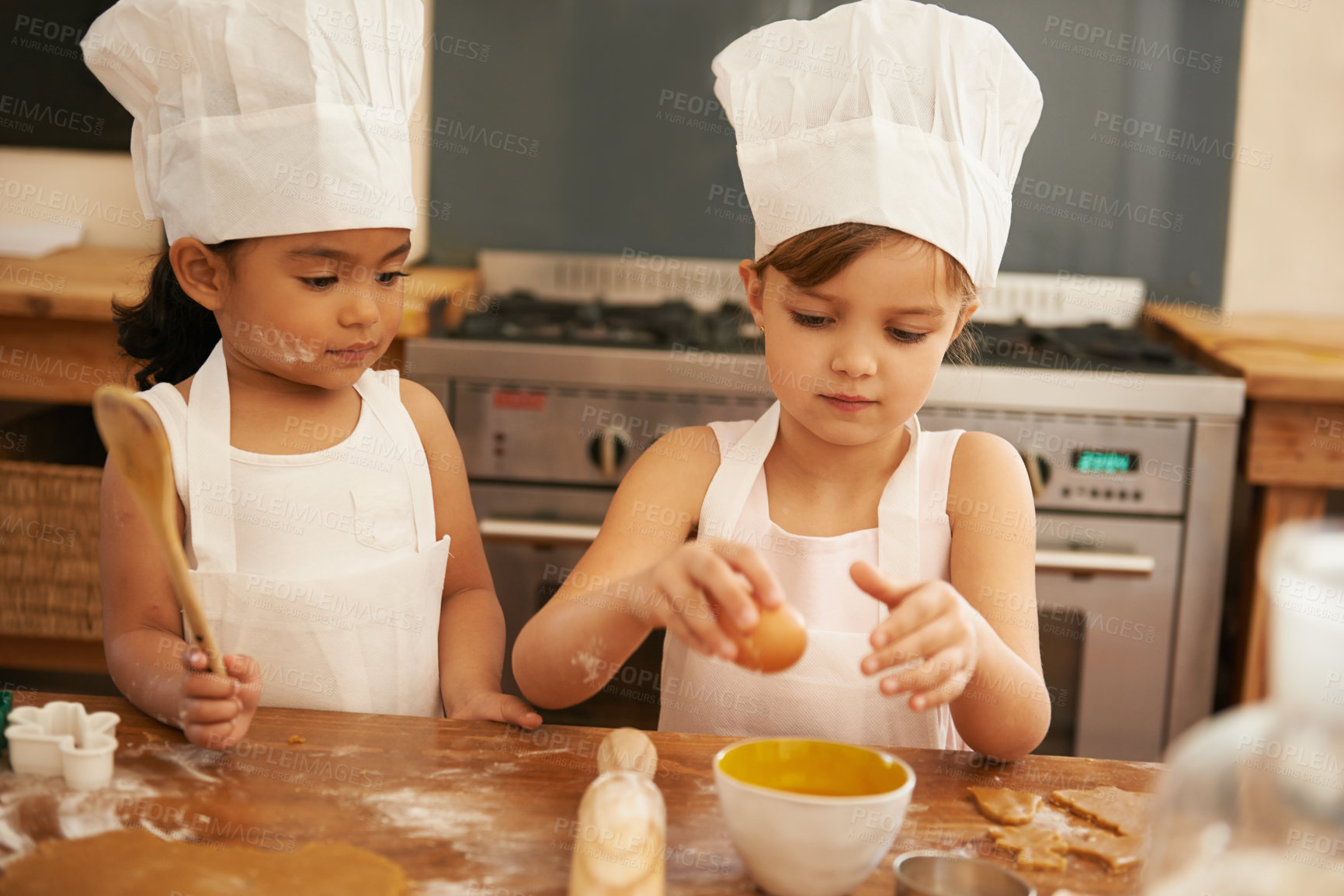 Buy stock photo Children bake in kitchen for learning and development of baker skill, fun with baking ingredients and chef hat with apron. Childhood, focus and girl kids making cookies, diversity and work together.