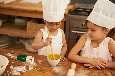 Buy stock photo Children, learning and baking in a kitchen with girls bonding, curious and mixing egg for cake in their home. Kids, cooking and siblings having fun with cookies, recipe and development activity