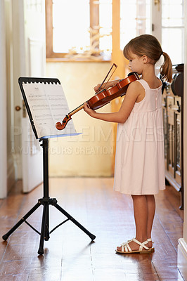 Buy stock photo Violin, girl and kid playing in home, learning and practice for education, music or reading sheet. Art, fiddle or child with bow for talent, creative or hobby in house with acoustic string instrument