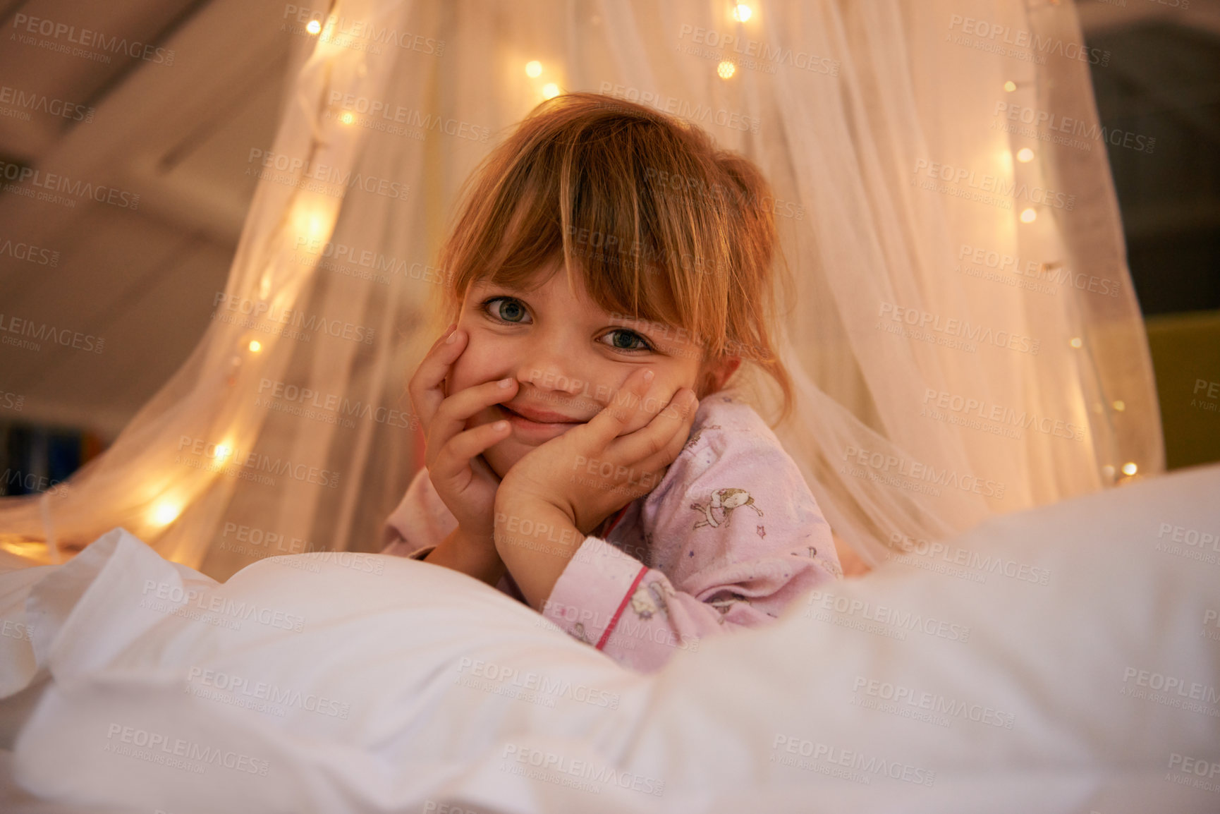 Buy stock photo Bedroom, lights and portrait of child at night for resting, relaxing and dreaming in home. Happy, smile and face of young girl with fairy light decoration on bed for fantasy, magic and childhood