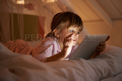 Buy stock photo Child, bedroom and tablet at night, relaxing and watching with technology for streaming or browsing. Little girl, tech and internet for online games or digital reading with touch and playing in bed