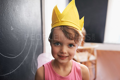 Buy stock photo Portrait, paper crown and child with smile for birthday celebration at kindergarten in Germany. Kid, female student or girl beaming in classroom with blackboard for party, fun and play inside