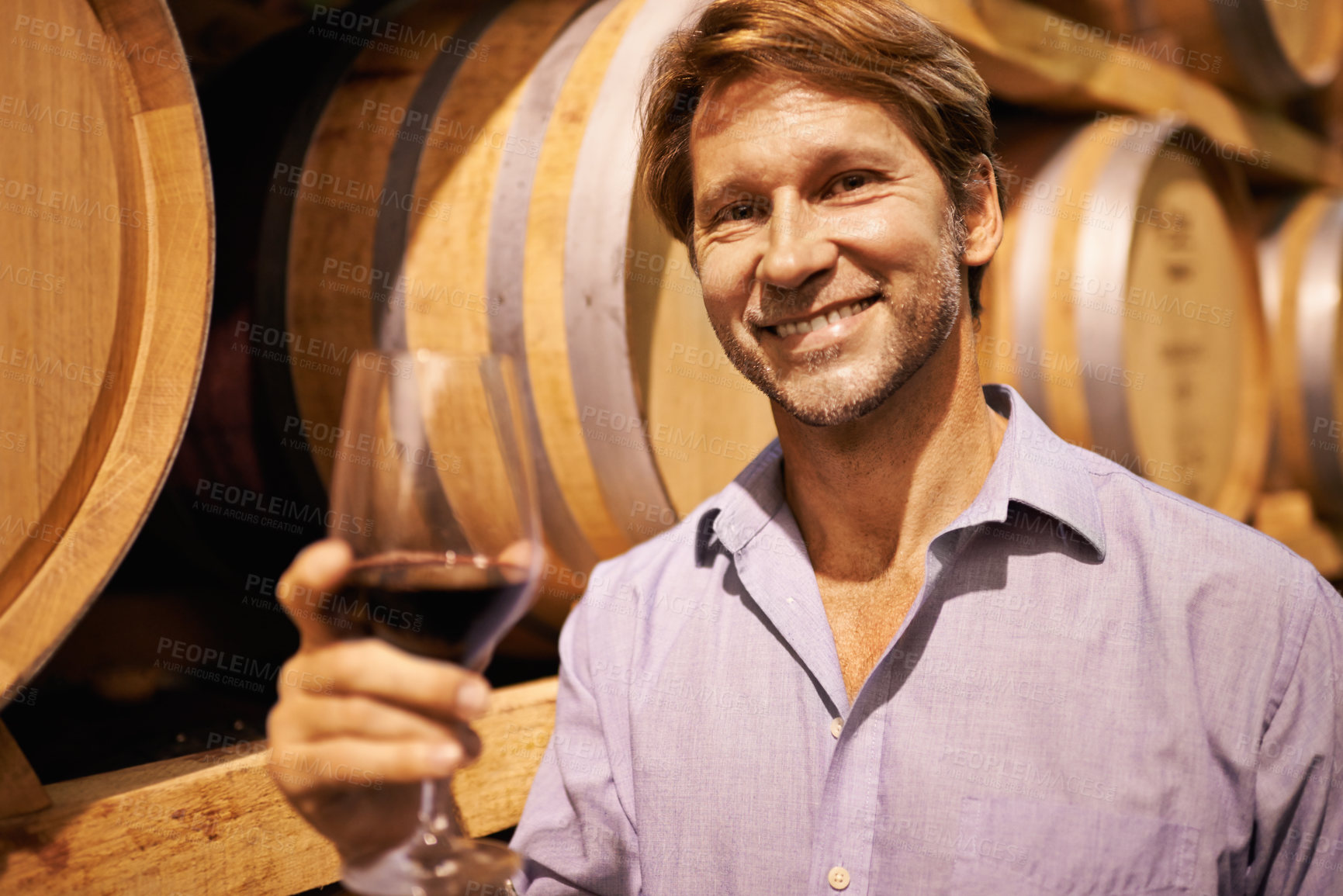 Buy stock photo Portrait, wine and taste with a man in the cellar of a distillery on a farm for production or fermentation of alcohol. Glass, winery and barrel with a male farmer tasting a drink for quality control