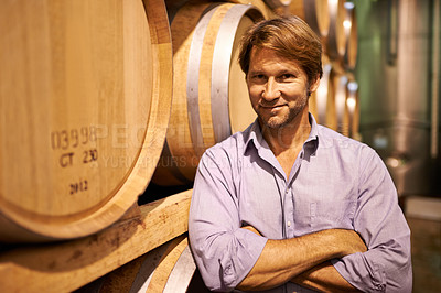 Buy stock photo Portrait, smile and wine tasting with a man in the cellar of a distillery on a farm for the production of alcohol. Glass, industry and barrel with a happy male farmer or sommelier for quality control