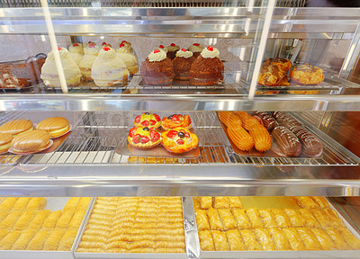 Buy stock photo Shot of pastry behind window glass at a bakery