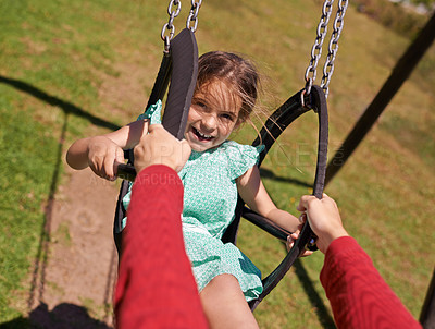 Buy stock photo Portrait, girl and parent on swing in park for summer vacation and fun in a field outside. Little child, family and push while on playground equipment and excited in a garden for bonding on vacation