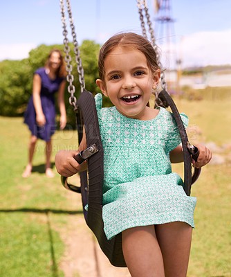Buy stock photo Portrait, happy little girl ride on swing and in the park watching sunset. Cute toddler, having fun woman swinging her daughter and in kindergarten or leisure activity and weekend summer playground