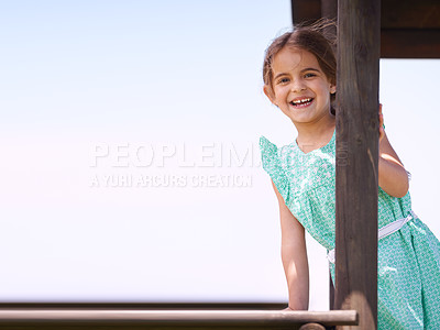 Buy stock photo Portrait of a little girl playing on a jungle gym on a sunny day