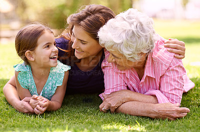 Buy stock photo Grandmother, mom and child hug outdoor to relax in summer, holiday or vacation together. Happy, family and elderly mother smile on grass with kid in garden with love and support in retirement