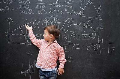Buy stock photo Child, boy and blackboard with math or equations for knowledge, numbers and hand gesture in classroom at school. Kid, student and learning by chalkboard for problem solving, studying and preschool