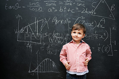 Buy stock photo Kid, boy and face with smile by blackboard with equations, numbers and problem solving in classroom at school. Child, student and happy for knowledge, learning and chalkboard with math and preschool
